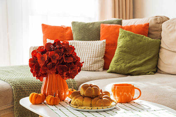 istock Autumn Living Room with Sofa, Pillows and Pumpkin Cinnamon Buns on Coffee Table 2246719233