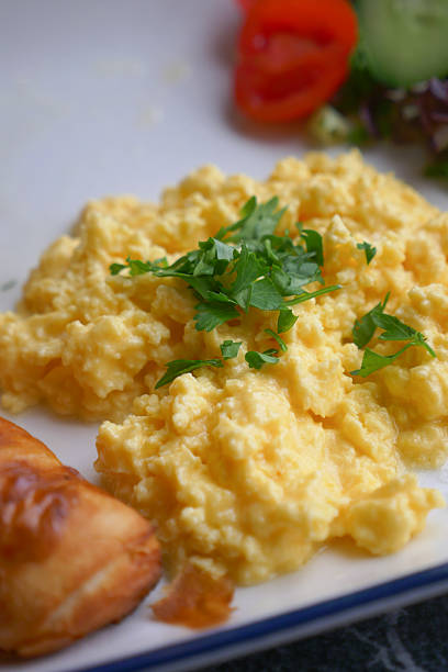 Scrambled eggs with herbs and a side of fresh vegetables