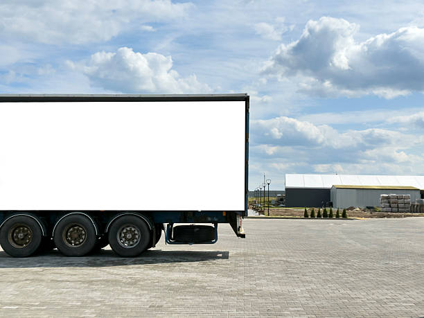 istock White truck trailer with blank advertising space 2246723460