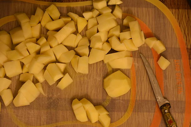 istock Diced Potatoes on Cutting Board with Knife Top View 2246730067