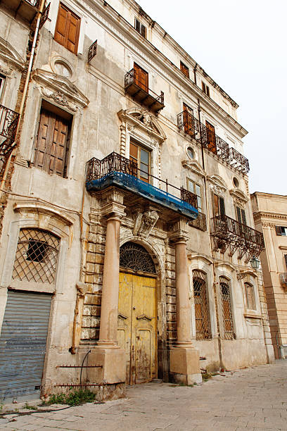 istock Rustic Old Town Facade With Iron Balcony, Weathered Shutters, and Aged Stonework 2246734201
