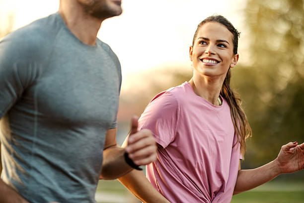 istock Happy couple running outdoors enjoying morning exercise 2246735078