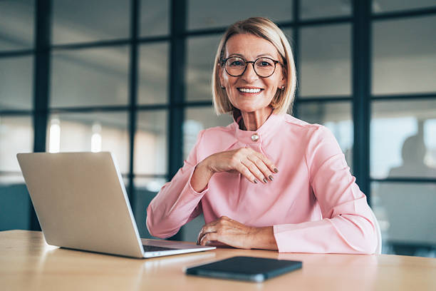 istock Confident mature businesswoman analyzing finance data in office 2246741435