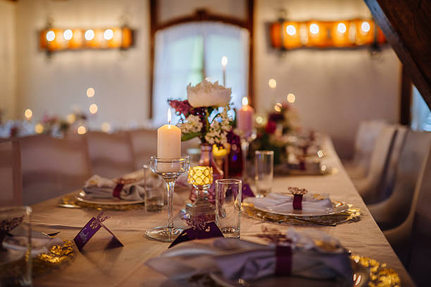 istock Elegant dining table set for a festive celebration, adorned with candles, floral arrangements, and decorative tableware, creating a warm and inviting atmosphere for guests 2246741618
