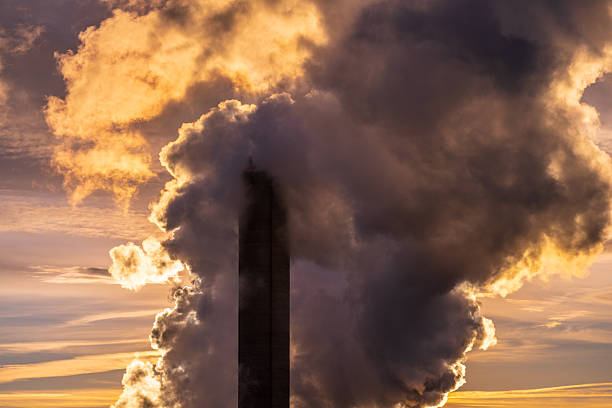 istock Dark industrial smoke clouds illuminated by dramatic golden light.. 2246742222
