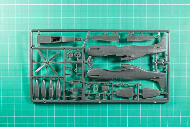 Plastic aircraft model kit parts on green cutting mat.