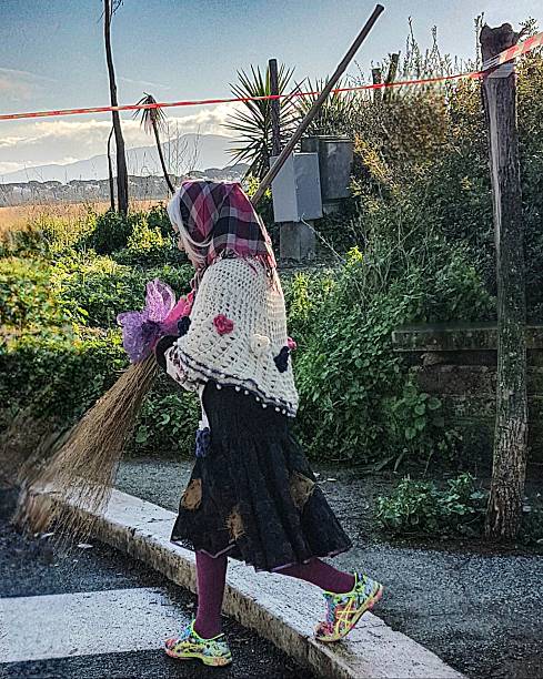 A person dressed as the Befana walks with a broom and colorful sneakers near the Parco degli Acquedotti in Rome during Epiphany celebrations. Rome, Italy, Jan. 6, 2025