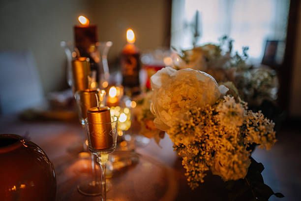 istock Elegant floral arrangement featuring peonies and candles on a beautifully set table, creating a warm and inviting atmosphere for a special occasion or celebration 2246742565