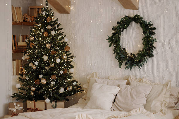 istock Scandi loft bedroom with Christmas tree and wreath on white textured wall 2246742718