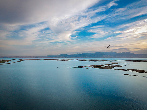 Breathtaking aerial view of tranquil waters and distant mountains.