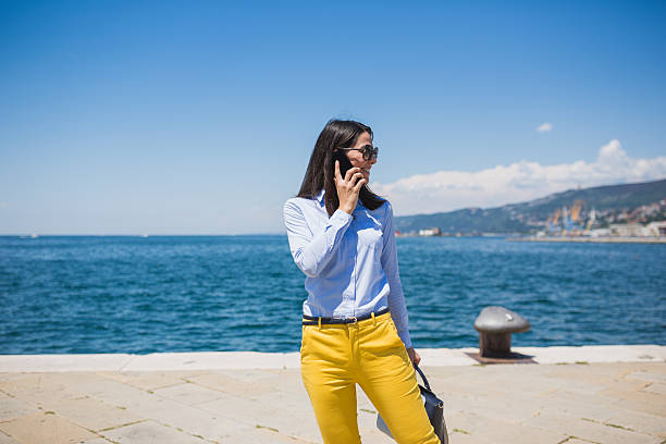 istock Seaside Stroll with Phone and Bag 2246756480