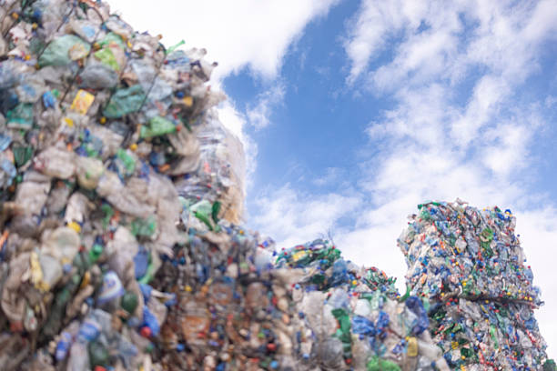 Large bales of compressed plastic bottles and other plastic waste, at a recycling facility