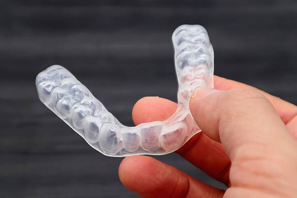 istock A person holding a mouthpiece for orthodontics 2246757376