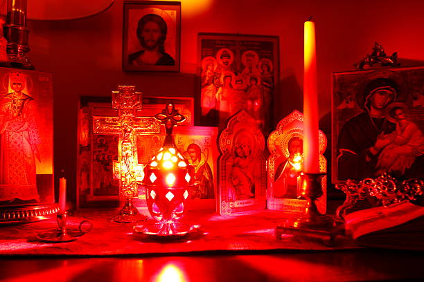 Eastern Orthodox Icons and Candles in a Dark Room