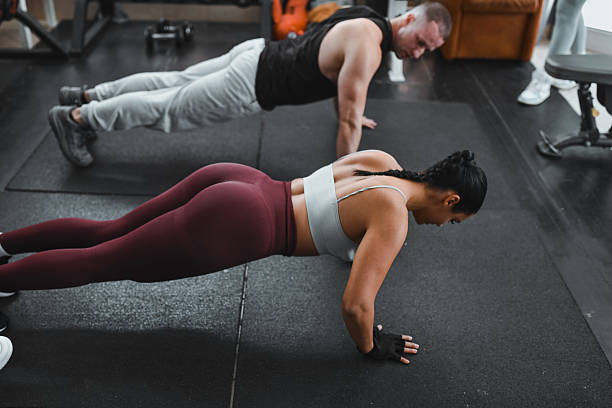 istock Intense Gym Workout: Man And Woman Do Push-Ups During Training Session 2246765106
