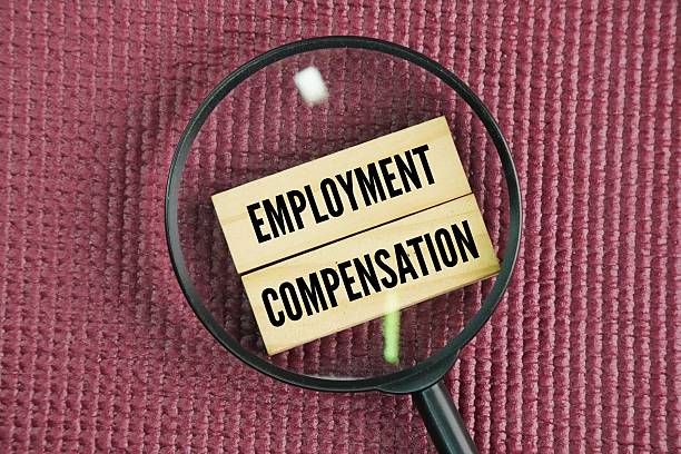 istock Magnifying glass and stick with the words Employment compensation 2246777419