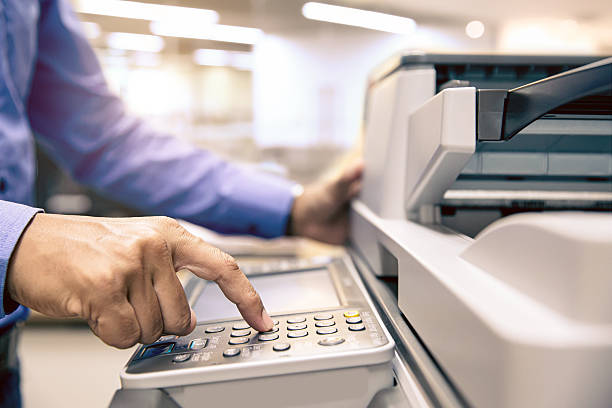 istock Photocopier printer, Close up hand office man press copy button on panel to using the copier or photocopy machine for scanning document or printing paper or Xerox a sheet. 2246778653
