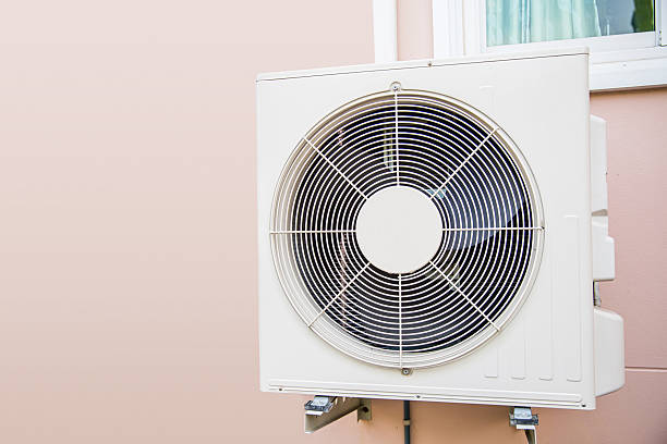 istock Air compressor, Close-up external split wall type of outdoor air conditioner compressor unit installed on outside building. Concepts of heater or heat and air conditioning system maintenance. 2246778988