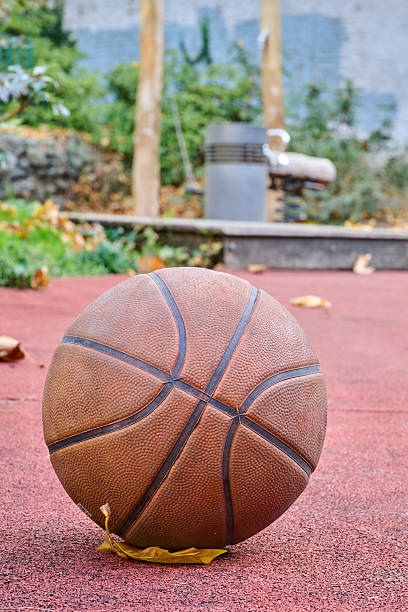 istock Well used basket ball on ground 2246779289