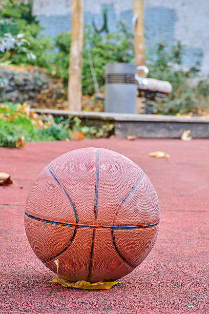 istock Well used basket ball on ground 2246779290