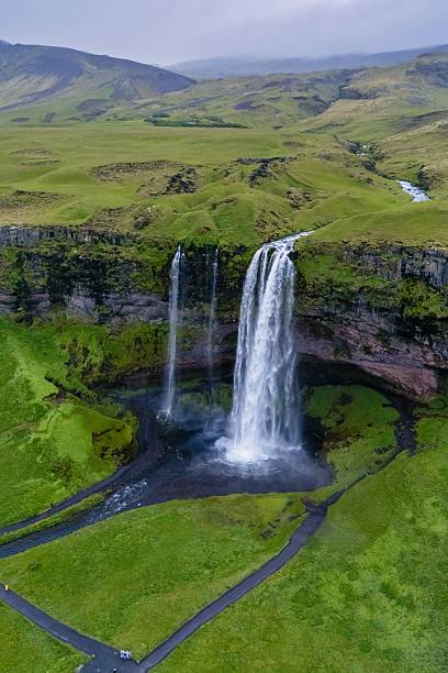 istock Majestic Seljalandsfoss waterfall cascading through lush Icelandic landscape during a cloudy day 2246779880
