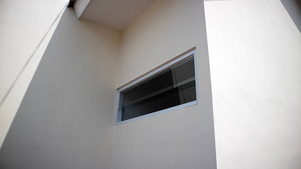 istock Minimalist white exterior wall with narrow horizontal window 2246783221
