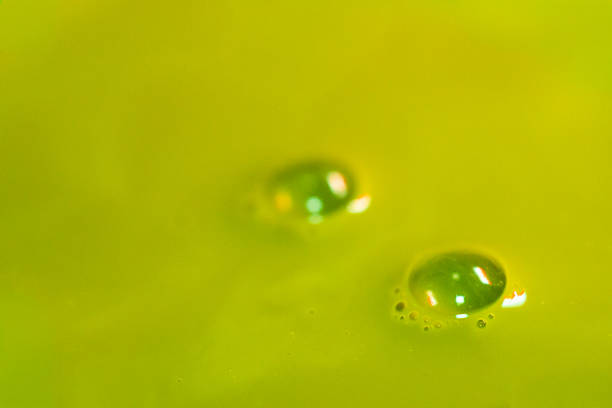 Macro shot focusing on gentle swirl patterns and natural milk integration within the matcha latte. Abstract yet organic texture.
