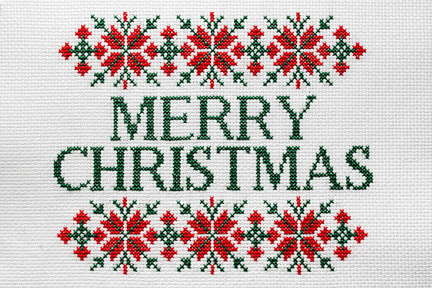 over the shoulder view of an elderly woman sewing a handmade christmas ornament with thread and needle.craft and christmas tree decoration.traditional winter celebration at home in december.
