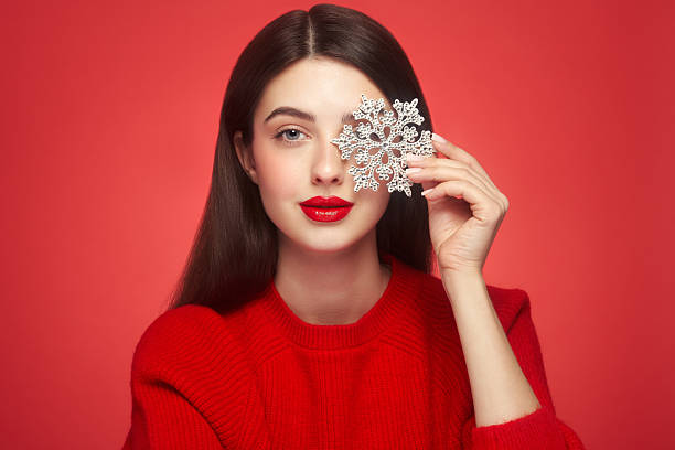 istock Beautiful young woman with glowing snowflake 2246788554