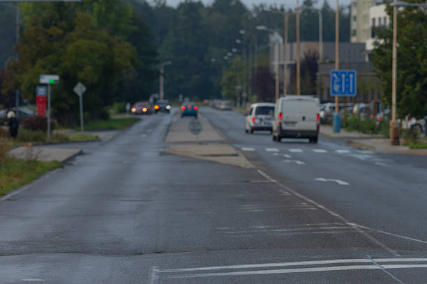 istock Overcast highway with reflections, Damp suburban pathway under cloudy skies 2246790876