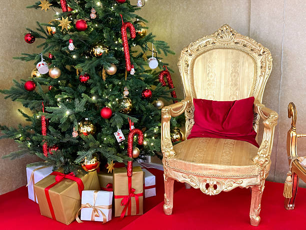 istock Santas golden chair near decorated Christmas tree 2246796232