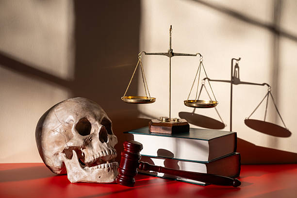 istock Scales of Justice and a Skull in a Light and Shadow Drawing 2246796453