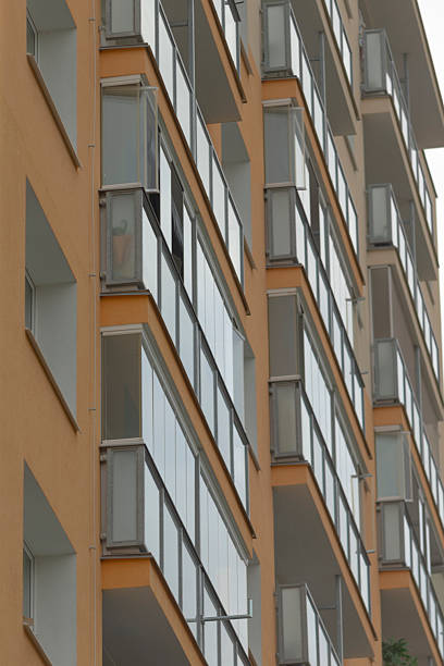 istock Contemporary Apartment Building Featuring Stylish Glass Balconies 2246800963