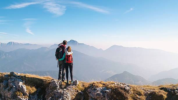 istock Couple enjoying mountain view at sunrise 2246804674