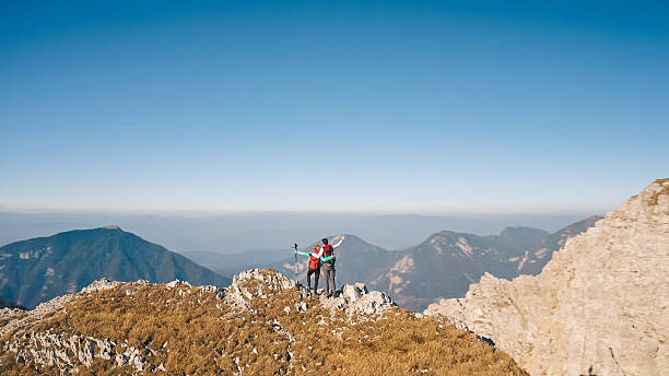 istock Scenic mountain summit with happy hikers 2246805217