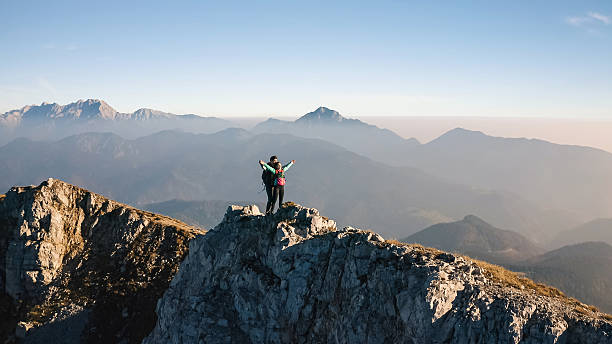 istock Adventurers reach summit at sunrise 2246805444