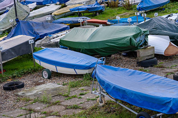 istock Small sailing boats packed away on the riverbank 2246805628