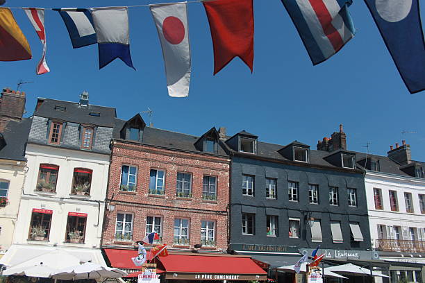 istock Flags and colourful buildings in Normandy 2246811180