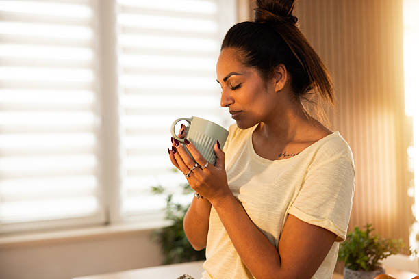 istock Woman Drinking Coffee In Kitchen 2246812712