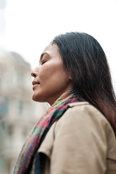istock Woman with closed eyes finding peace in city 2246816466
