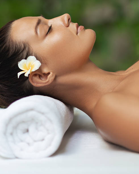 istock Young Woman Resting On Massage Table With Flower Luxury Spa Concept 2246817692