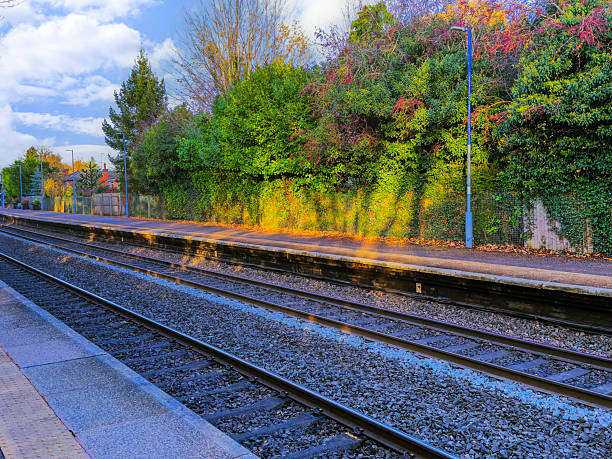 A station England UK. Diesel powered railway line in the English countryside. Station on a sunny day. Panoramic - Panorama.