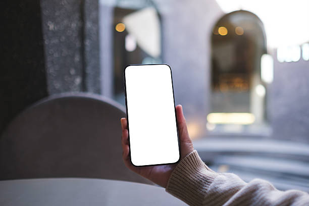 istock Mockup image of a woman holding and using mobile phone with blank desktop screen in cafe 2246821934