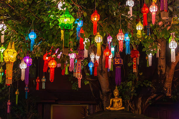 istock Vibrant Lanna lanterns illuminate a Bodhi tree at night, creating a mesmerizing spectacle above a golden Buddha statue, celebrating cultural traditions in Thailand. 2246822231