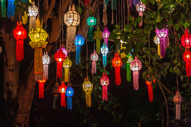 istock Vibrant Lanna lanterns illuminate a dark night, suspended from tree branches during a festive celebration in Northern Thailand. These traditional colorful lights create a magical, enchanting 2246822254