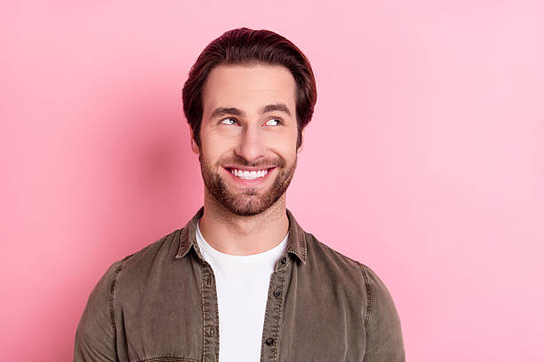 istock Portrait of attractive cheerful guy wearing casual shirt creating solution copy space isolated over pink pastel color background 2246823504
