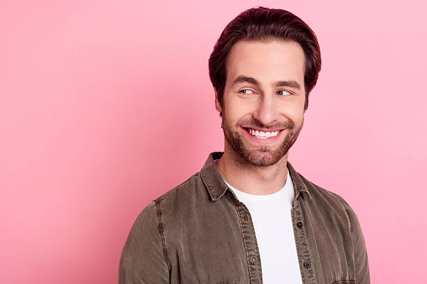 istock Portrait of attractive cheerful guy overthinking copy empty space isolated over pink pastel color background 2246824093