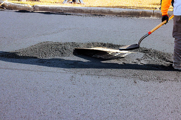 istock Road repair crew patching pothole in residential area 2246826493