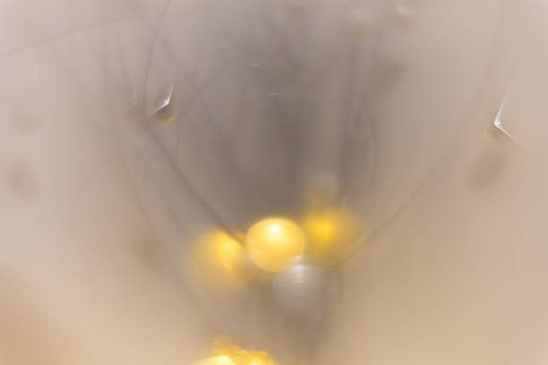The entire image is extremely blurred and enveloped in a warm, creamy haze, evoking a cozy holiday atmosphere. Ideal for seasonal designs, invitations, and backgrounds with themes of luxury, elegance
