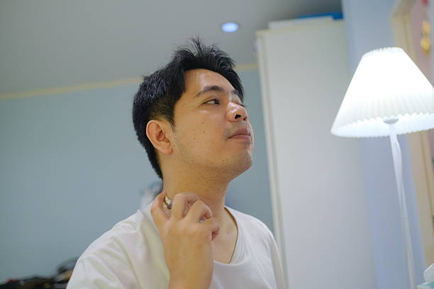 A man is getting ready for the day, putting on deodorant and fixing his hair. Concept of routine and self-care, as the man takes the time to groom himself before starting his day